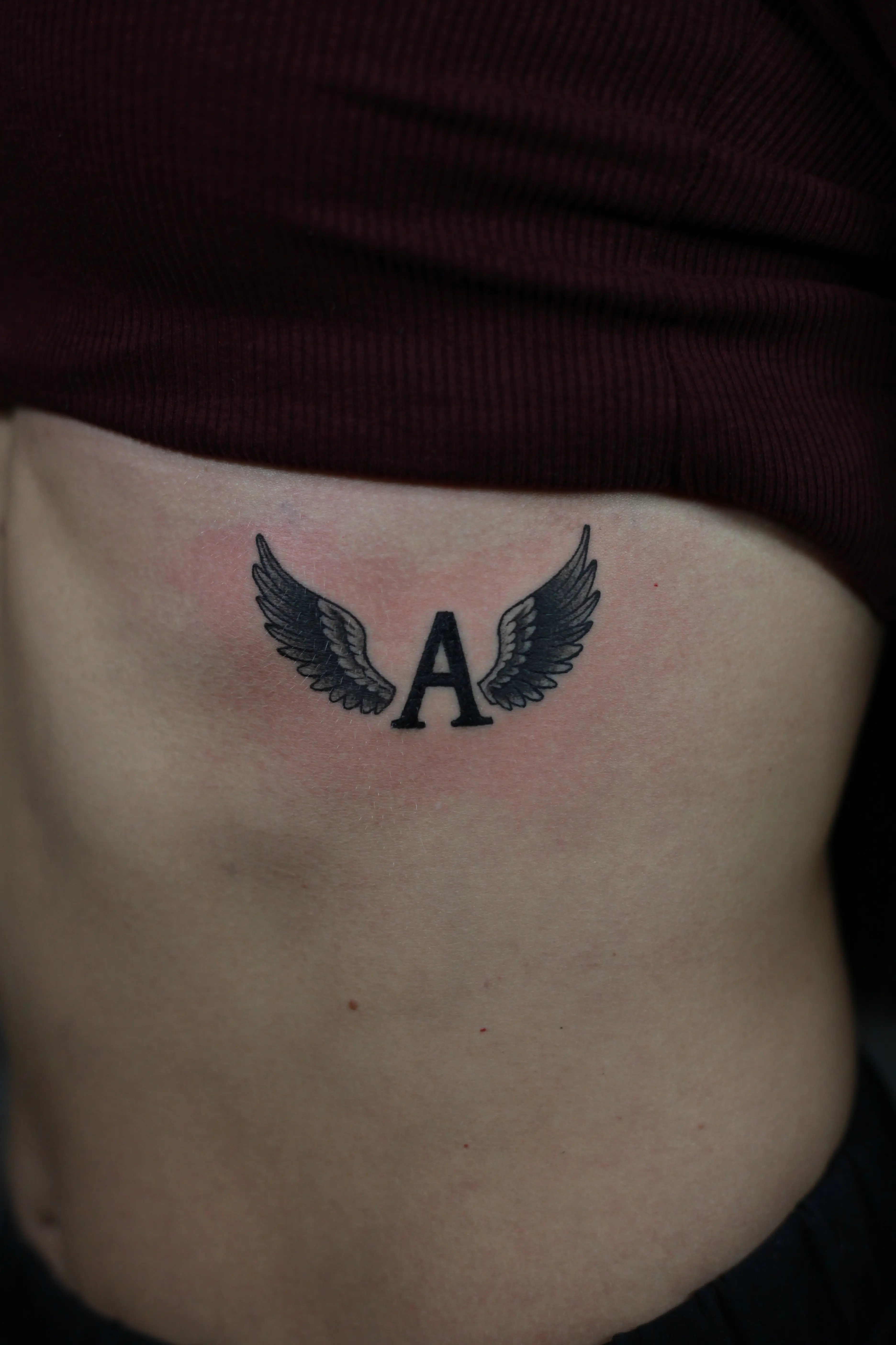 Tetovaža Slovo A sa krilima - Fine Line & Minimal - Eternal Art Tattoo Studio Loznica